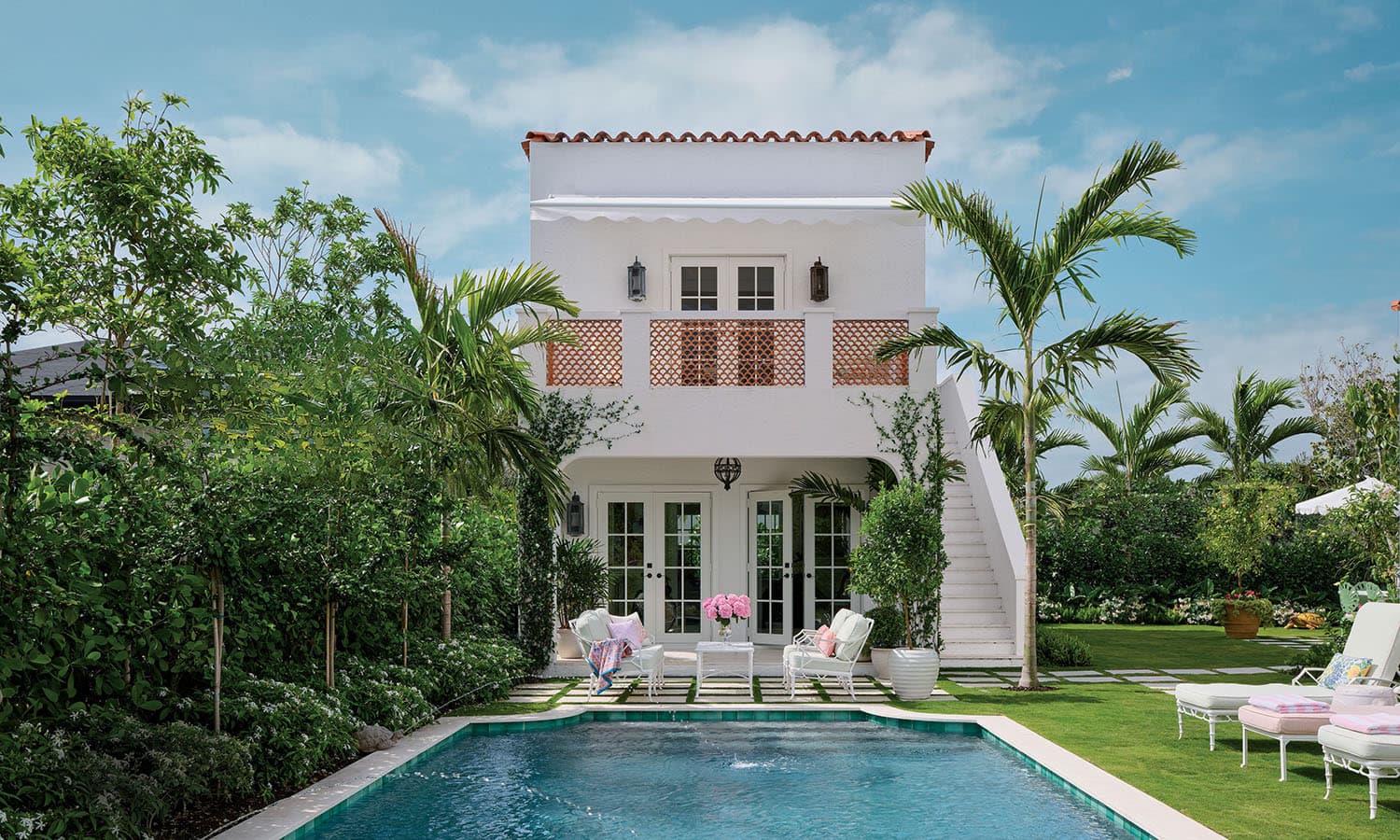 Modern Florida stucco home with queen palms — representing the housing affordability crisis