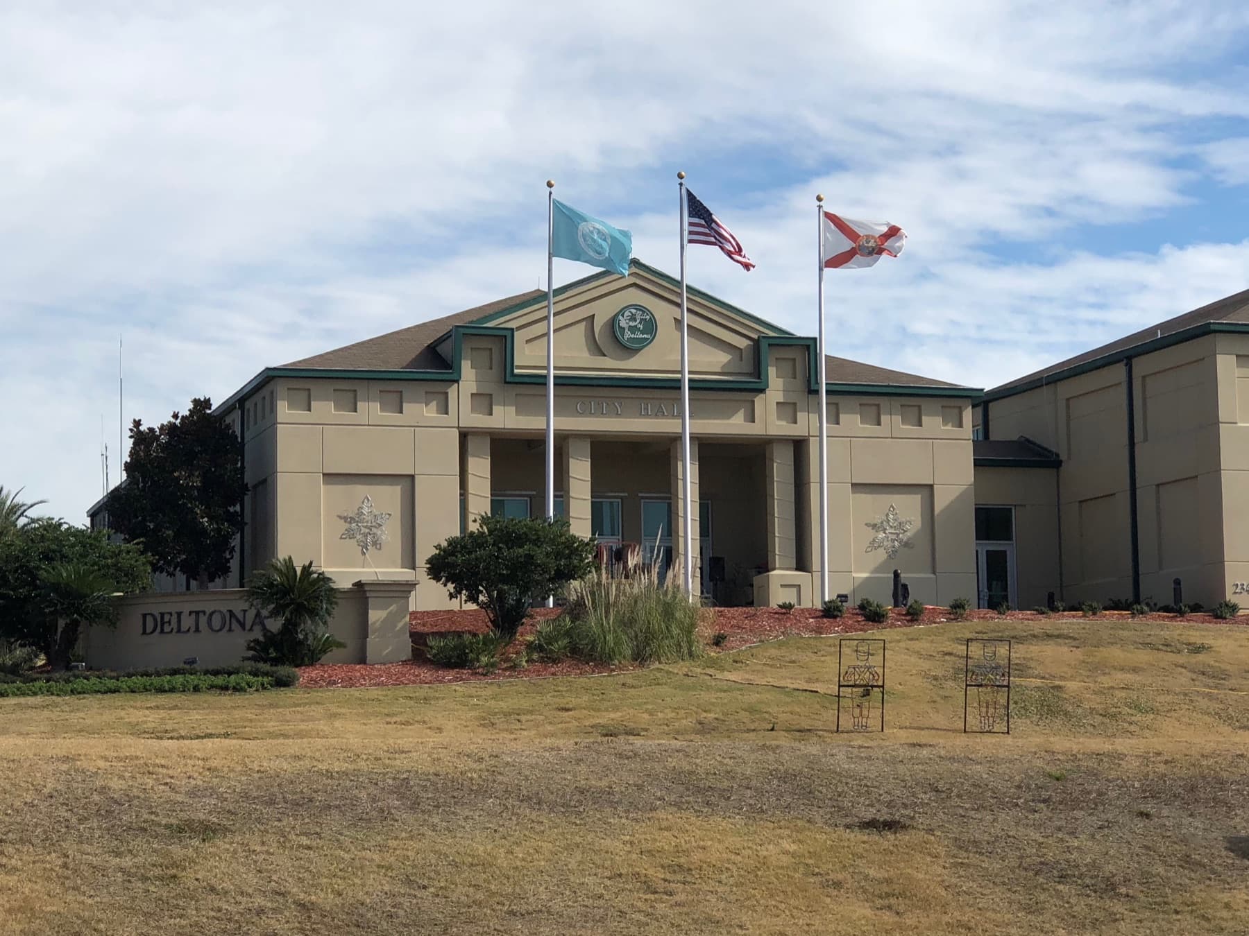 Deltona City Hall in Deltona, Florida, with the city sign and flags out front