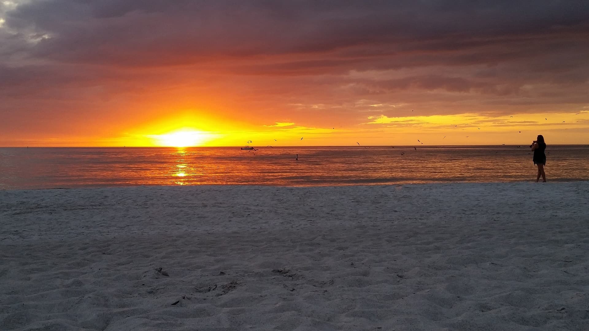 Sunset over the Gulf of Mexico from the sand at Madeira Beach, Florida