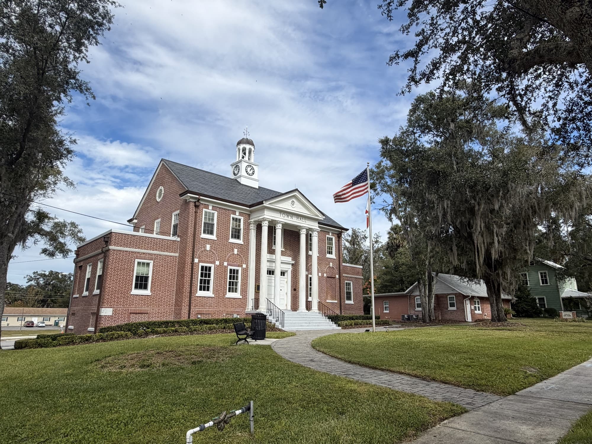 Orange City Town Hall, a red-brick building with white columns and a clock cupola, Orange City, Florida