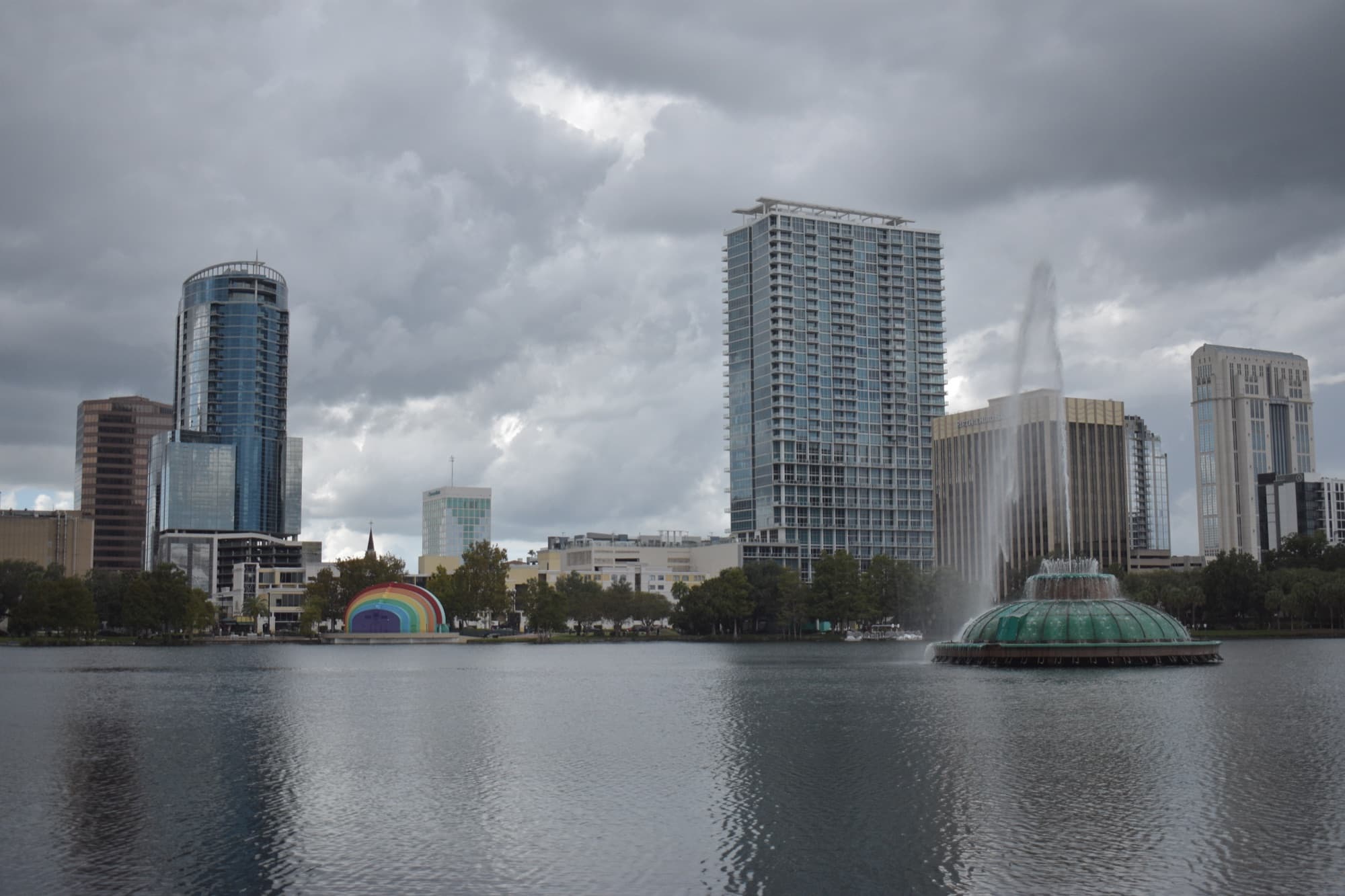 Downtown Orlando skyline and the Lake Eola fountain under a cloudy sky, Orlando, Florida