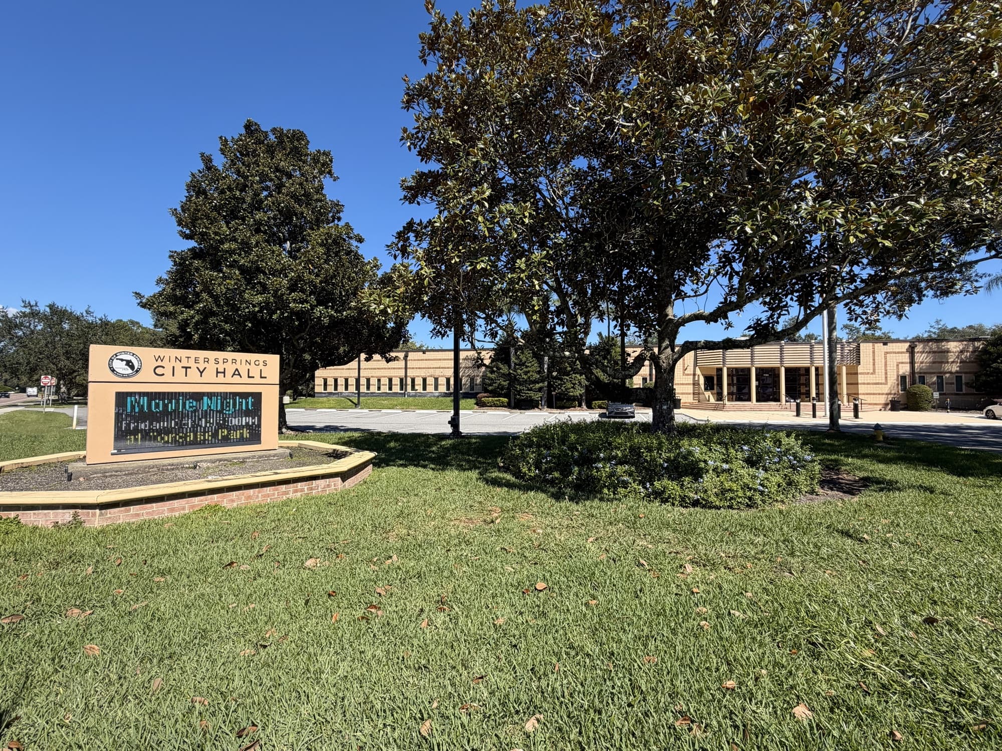 Winter Springs City Hall and its sign under oak and magnolia trees, Winter Springs, Florida