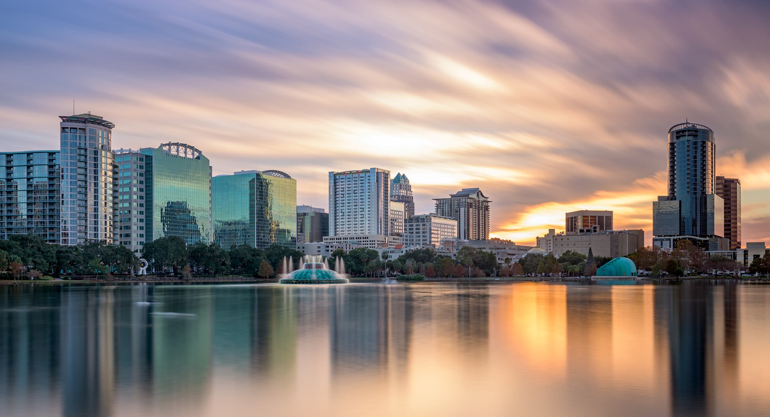 Downtown Orlando, Florida Class A office towers and high-rise skyline over Lake Eola — the office, retail, industrial, and multifamily building size spectrum of the Orlando commercial real estate market