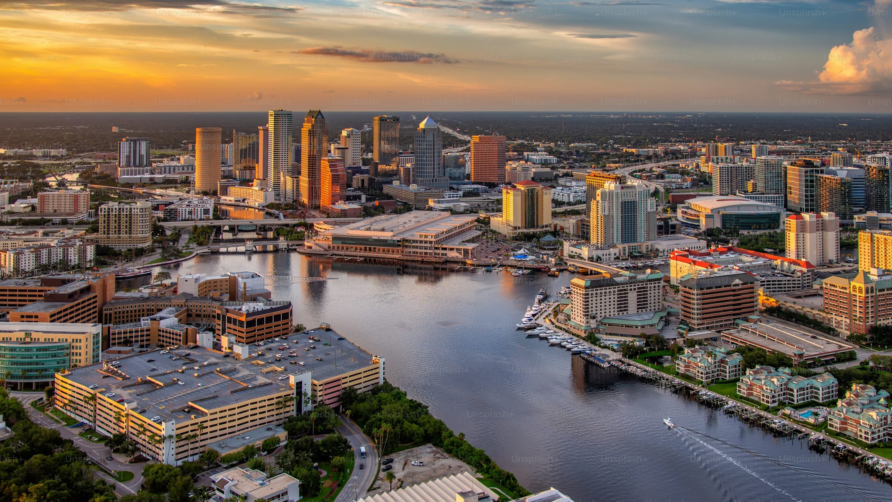 Aerial panoramic view of downtown Tampa Florida showing the full cluster of Class A office towers, Hillsborough River, and Tampa Bay waterfront